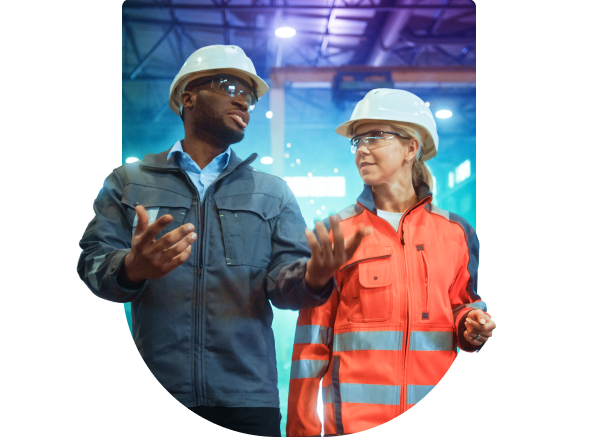 two people wearing hard hats and safety vests