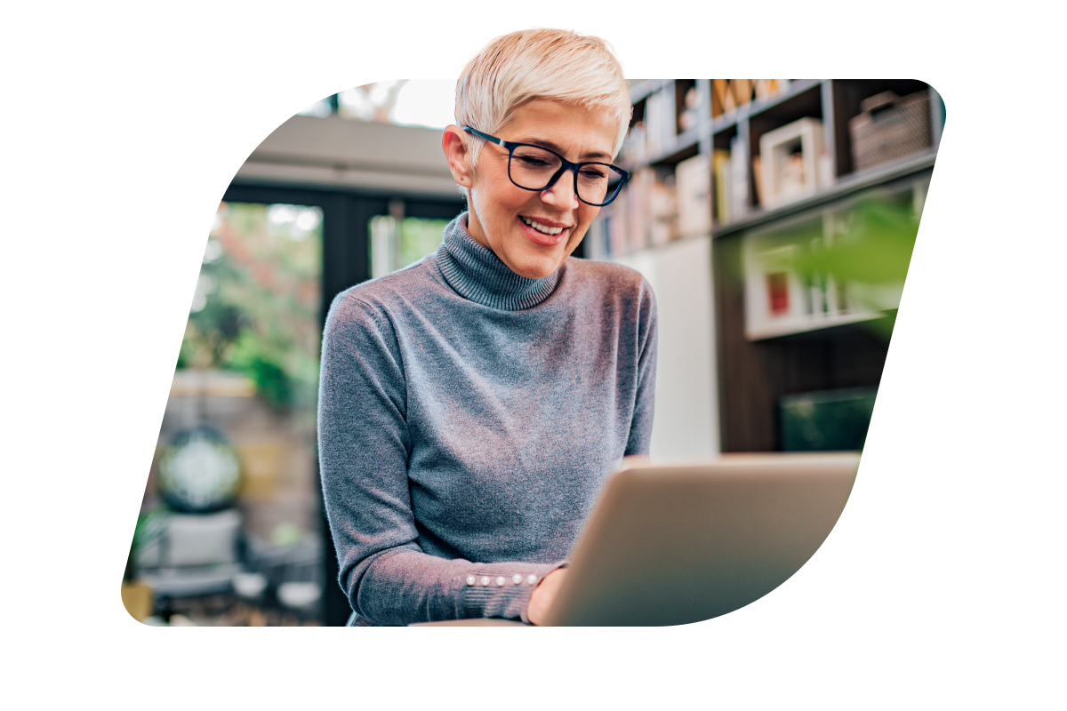 a woman wearing glasses and using a laptop