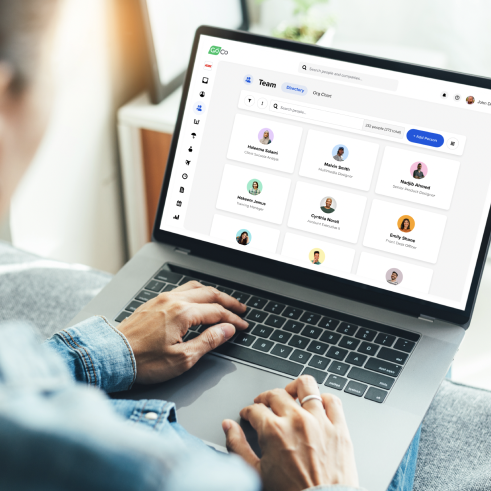 a person using a laptop with a group of people on the screen