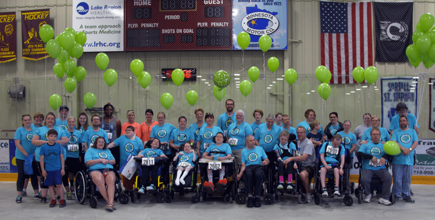 a group of people in wheelchairs posing for a photo
