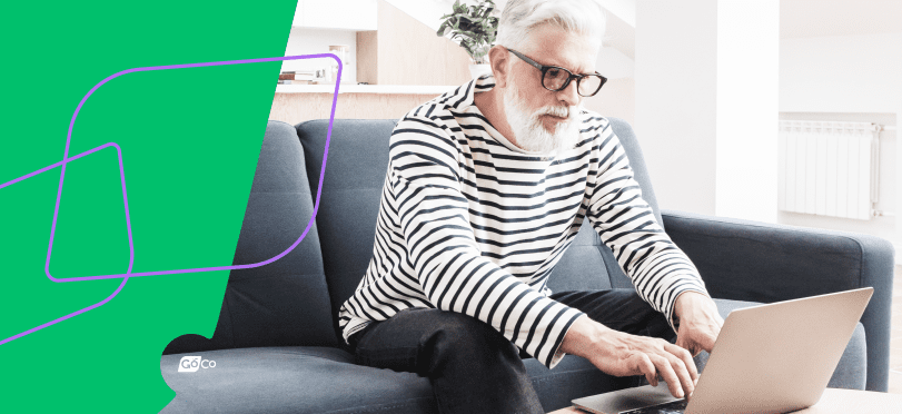 a woman sitting on a couch using a laptop