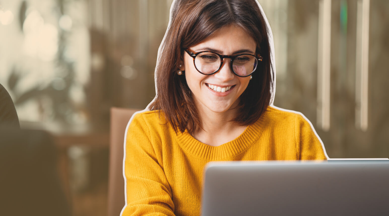 a woman in glasses using a laptop