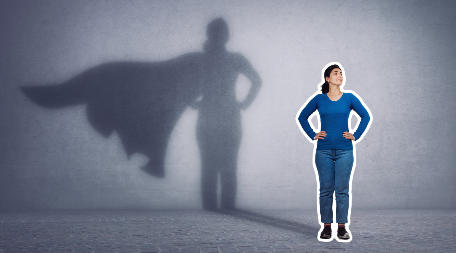 a woman standing in front of a wall with a shadow of a superhero