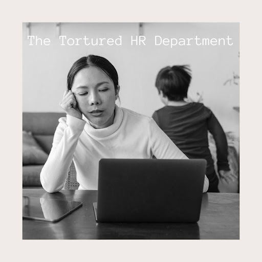 a woman sitting at a table with a laptop