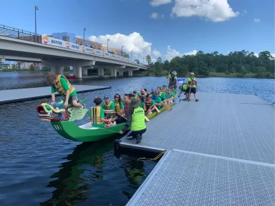 a group of people in canoes on a dock