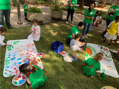 a group of children painting on a table