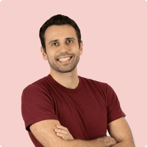 a man with his arms crossed and smiling