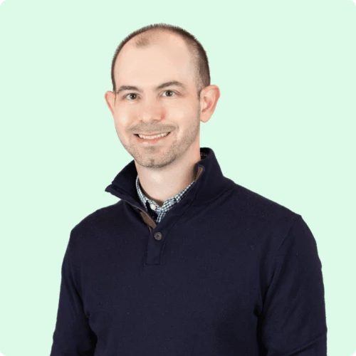 a man in a blue sweater and black pants