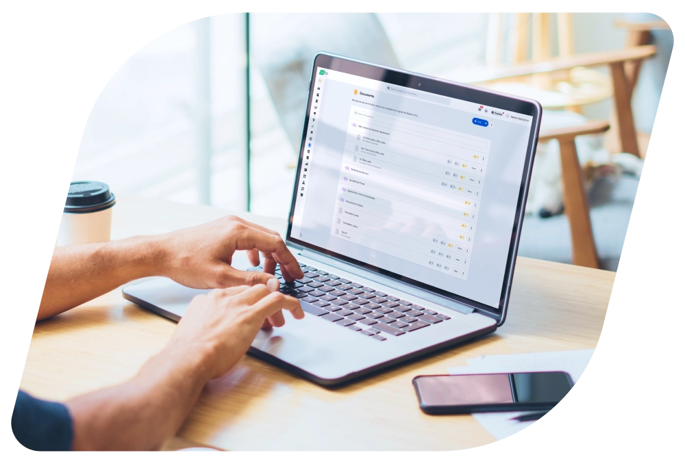 a person using a laptop with a facebook page on the screen