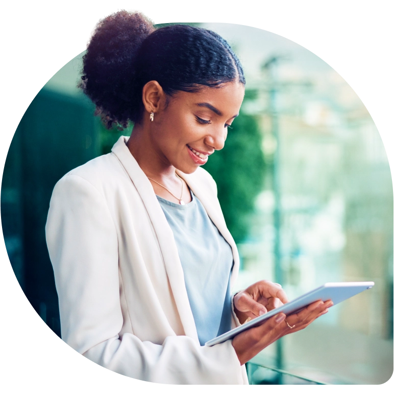 a woman in a white suit using a tablet