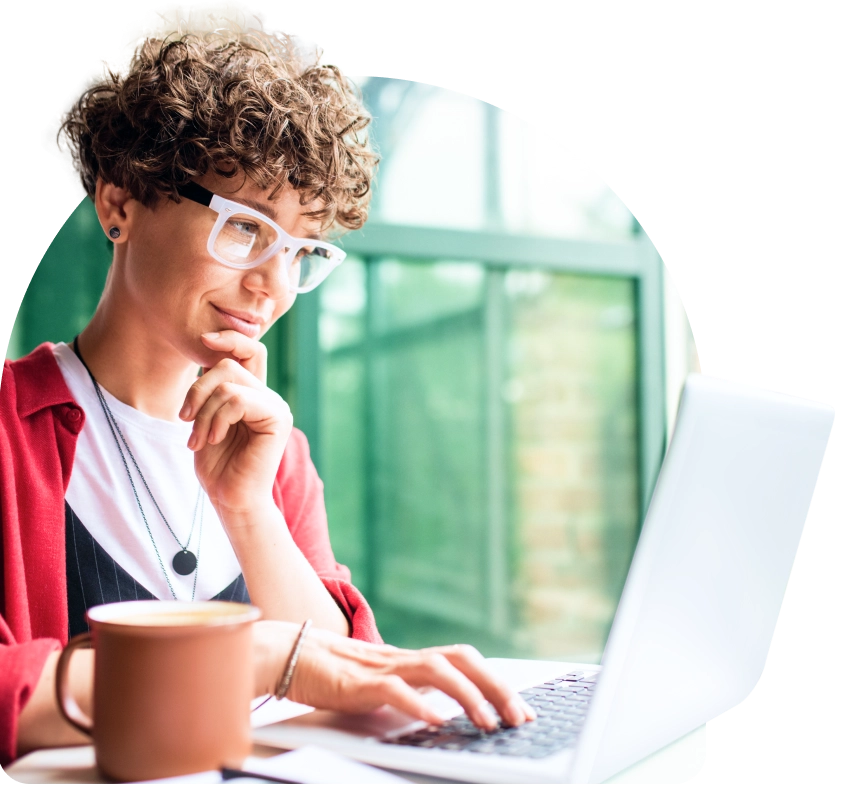 a young man in glasses using a laptop