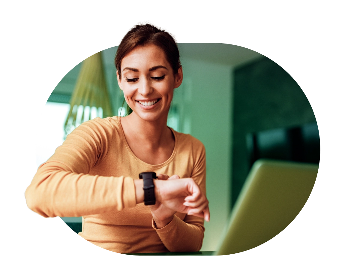 a woman is smiling while looking at her watch