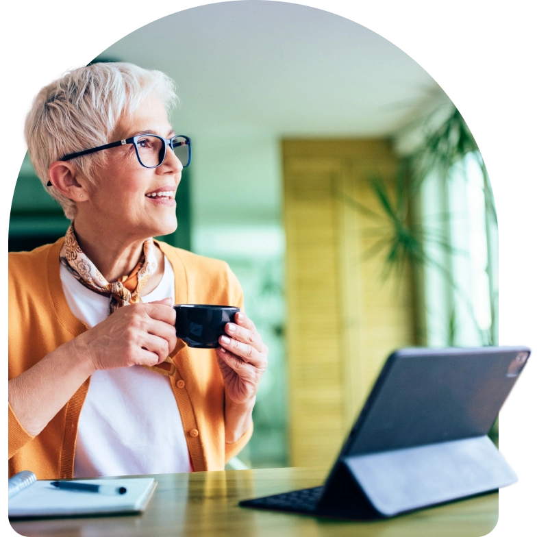 a woman holding a credit card and looking at a laptop