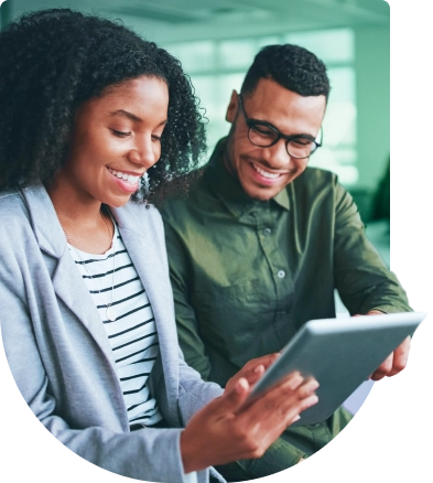 a man and woman looking at a tablet