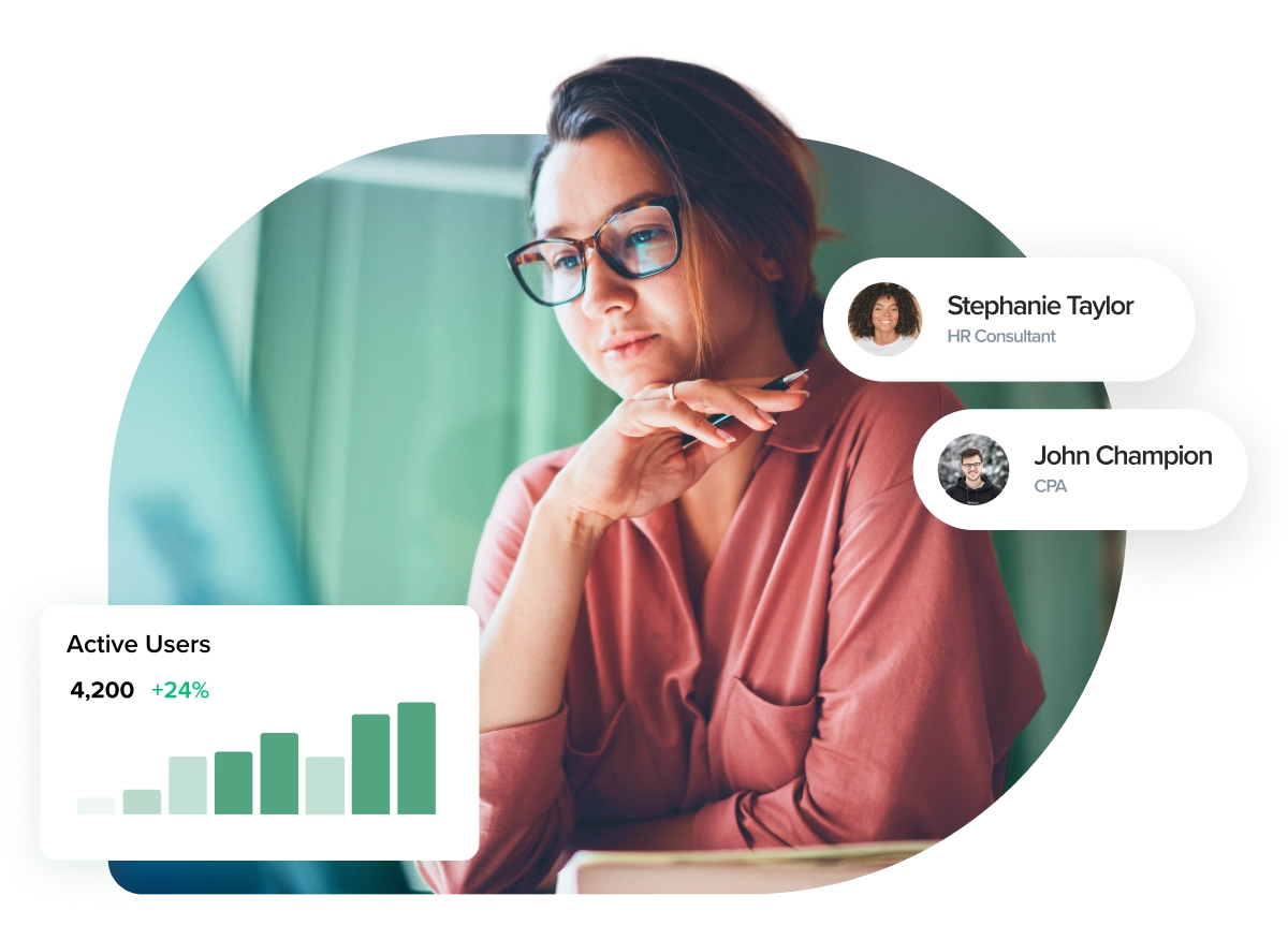 a woman with glasses looking at her laptop