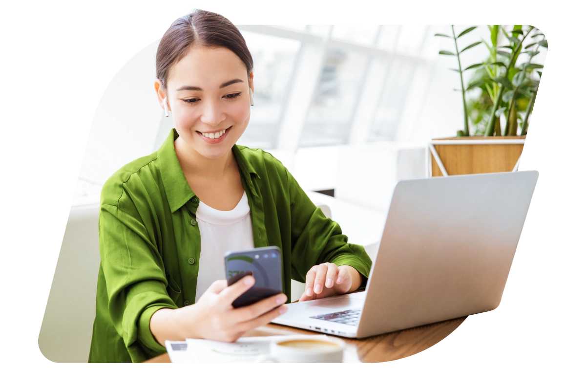 a woman sitting at a table using her laptop