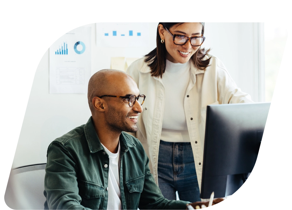 a man and woman looking at a computer