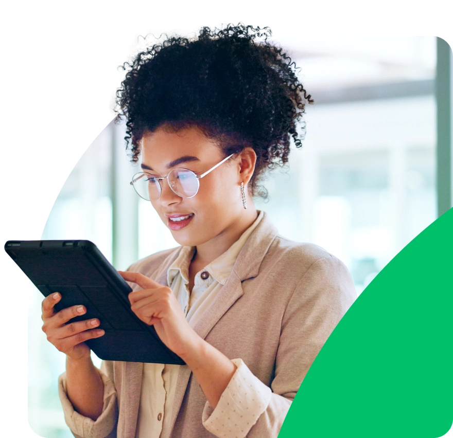 a woman in glasses using a tablet