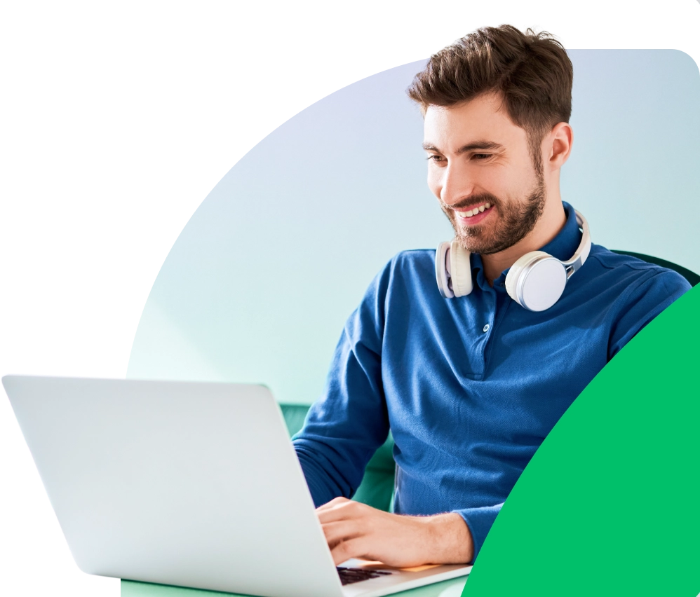 a man sitting at a desk with a laptop