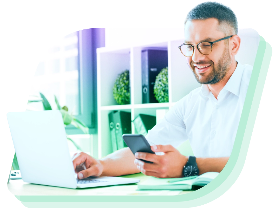 a man sitting at a desk using a laptop