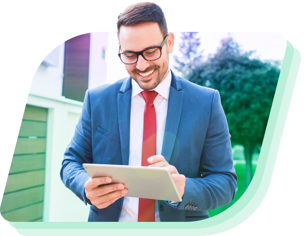 a man in a suit and tie using a tablet