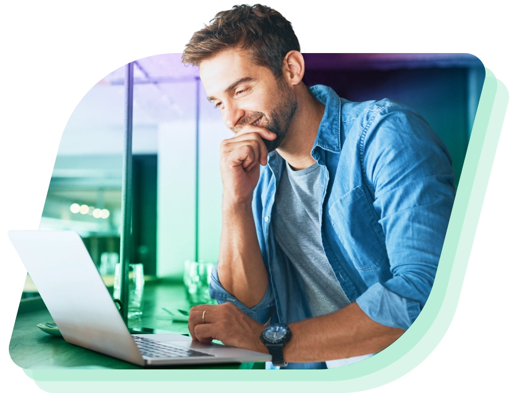 a man sitting at a desk with a laptop