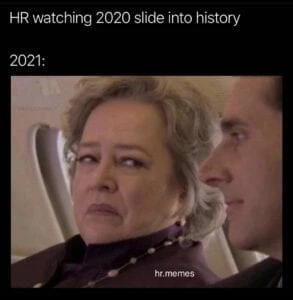 a woman sitting in a chair with a man