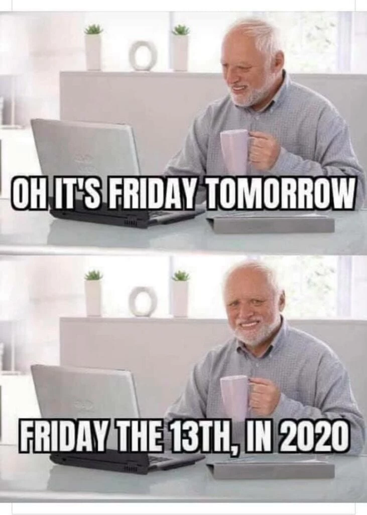 a man sitting at a desk with a laptop and a cup