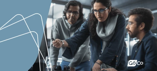 a group of people looking at a laptop