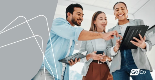 a group of people standing around a tablet