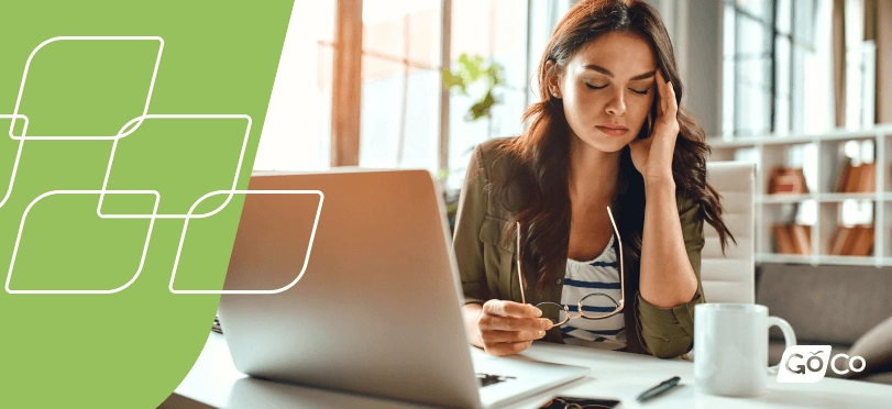 Woman feeling burned out and stressed at work. Office setting