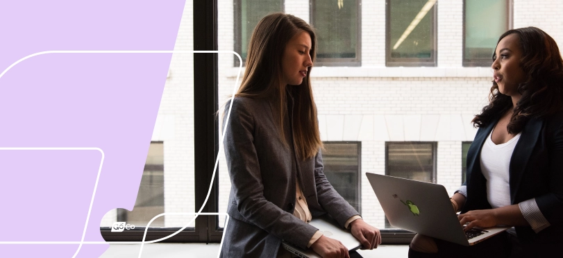 two women talking in an office