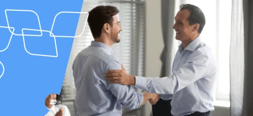 two men shaking hands in an office