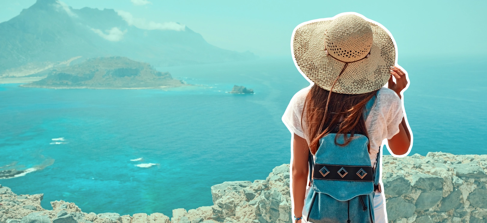 a woman in a hat looking at the ocean