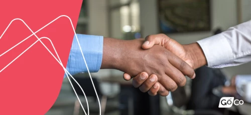 two men shaking hands in an office