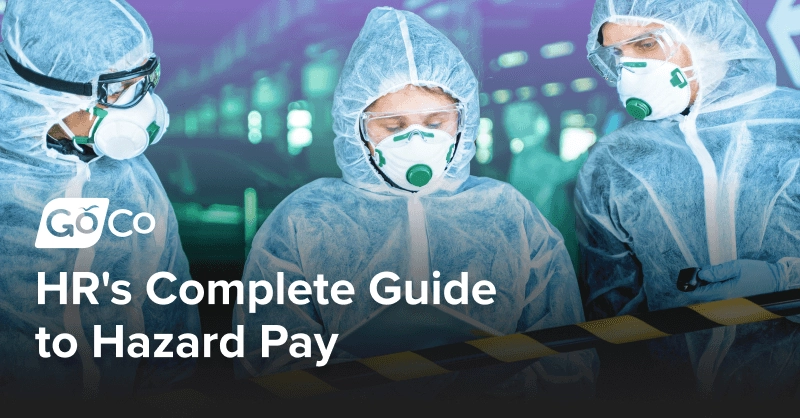 Two people wearing hazmart suits looking at a tablet.