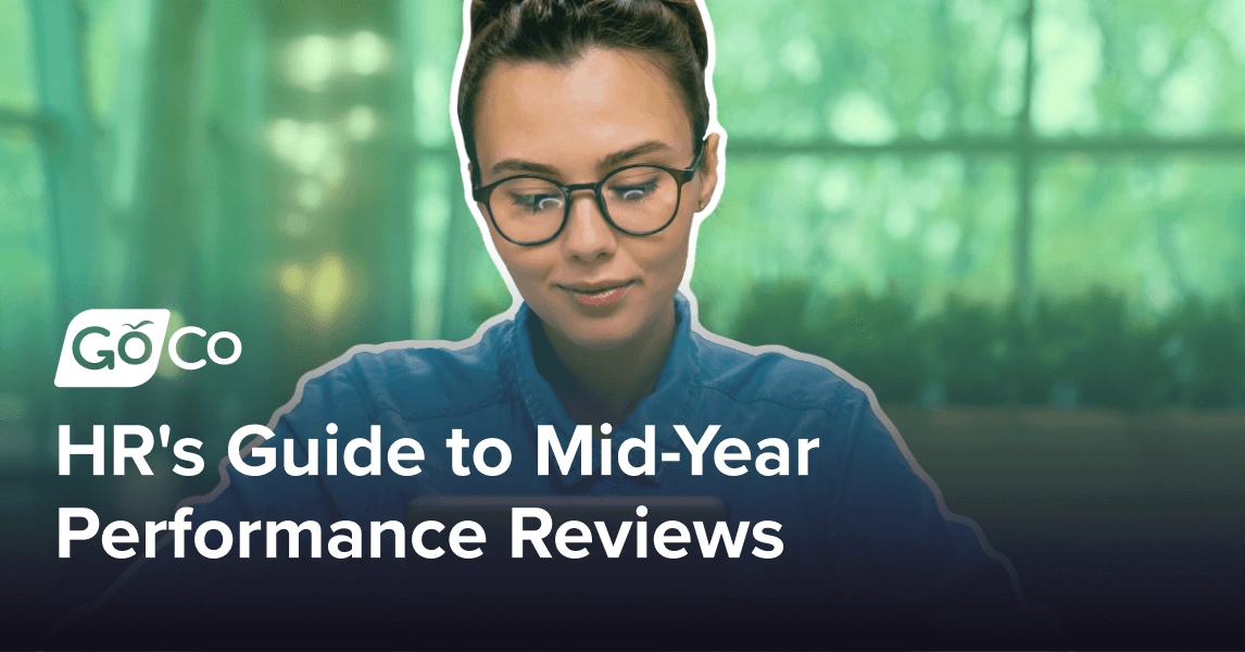 A woman wearing glasses and looking at a tablet.