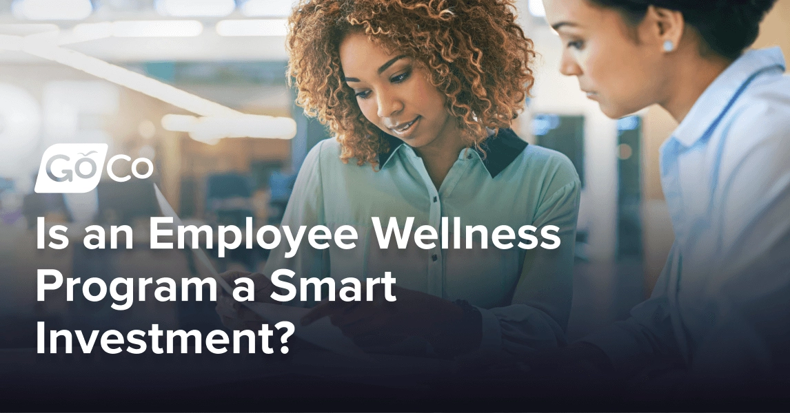 Two businesswomen consult a document.