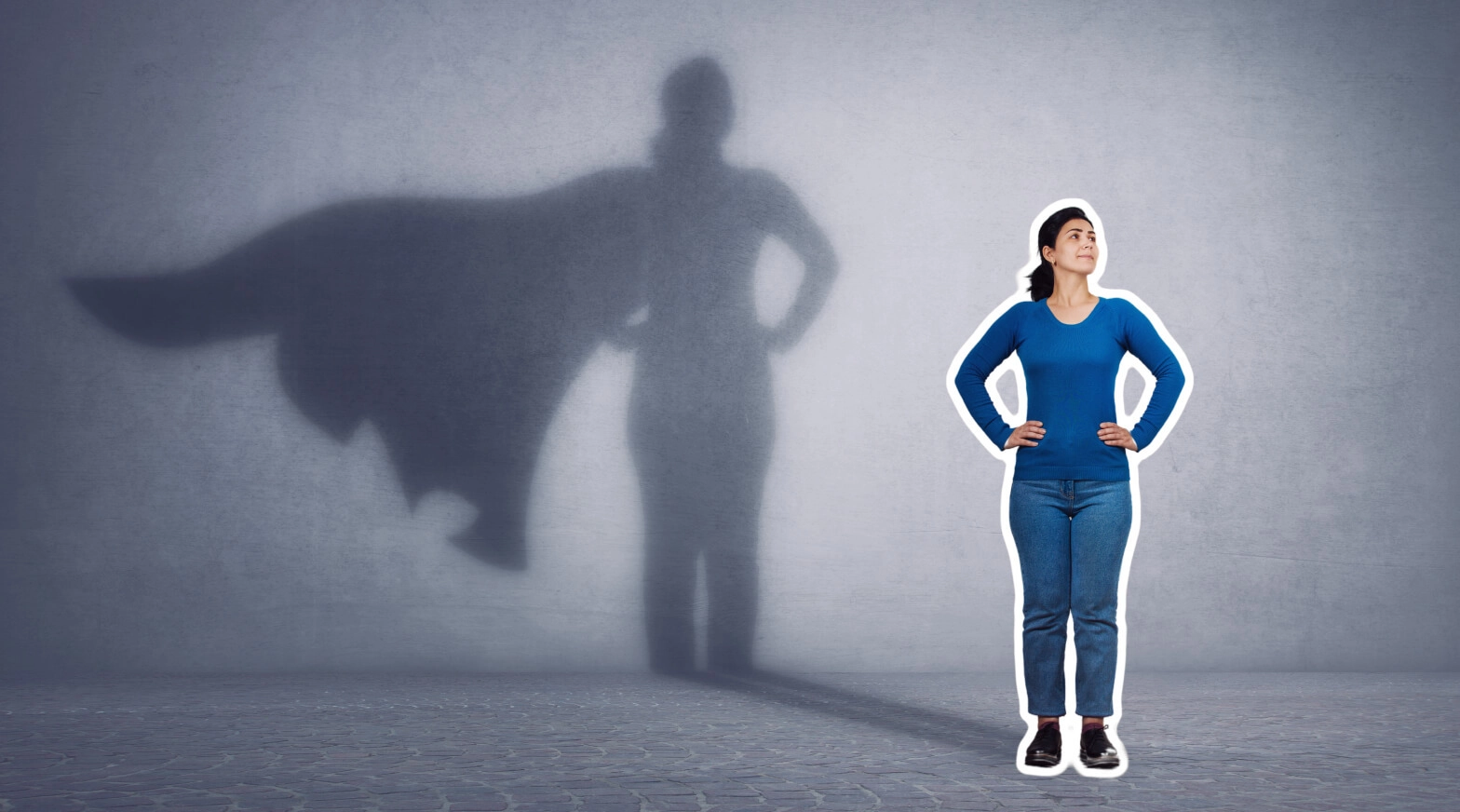a woman standing in front of a wall with a shadow of a superhero