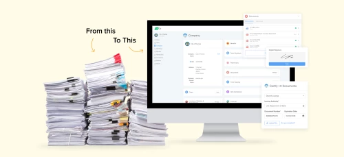 a computer and a monitor with a stack of papers on it