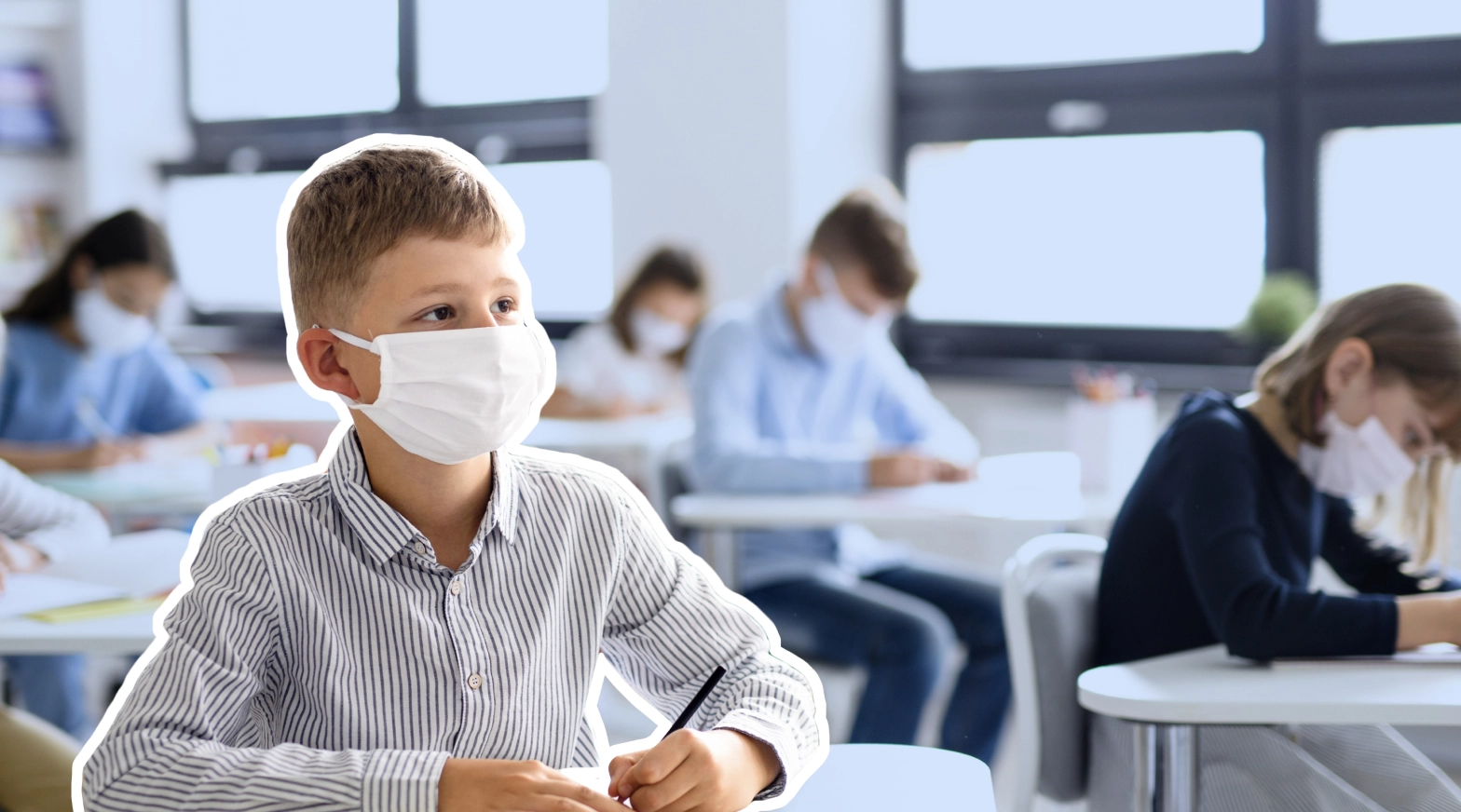 a boy wearing a mask in a classroom