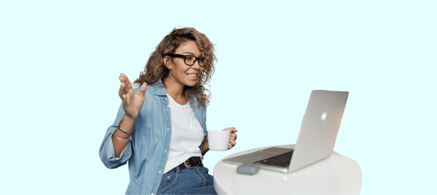 a woman standing in front of a laptop
