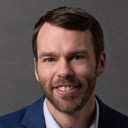 a man in a blue suit and white shirt