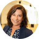 a woman in a blue jacket and white shirt