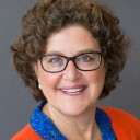 a woman in an orange shirt and glasses