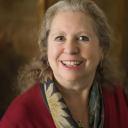 a woman with blonde hair and a red jacket