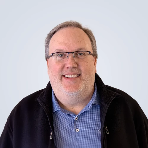 a man with glasses and a blue shirt